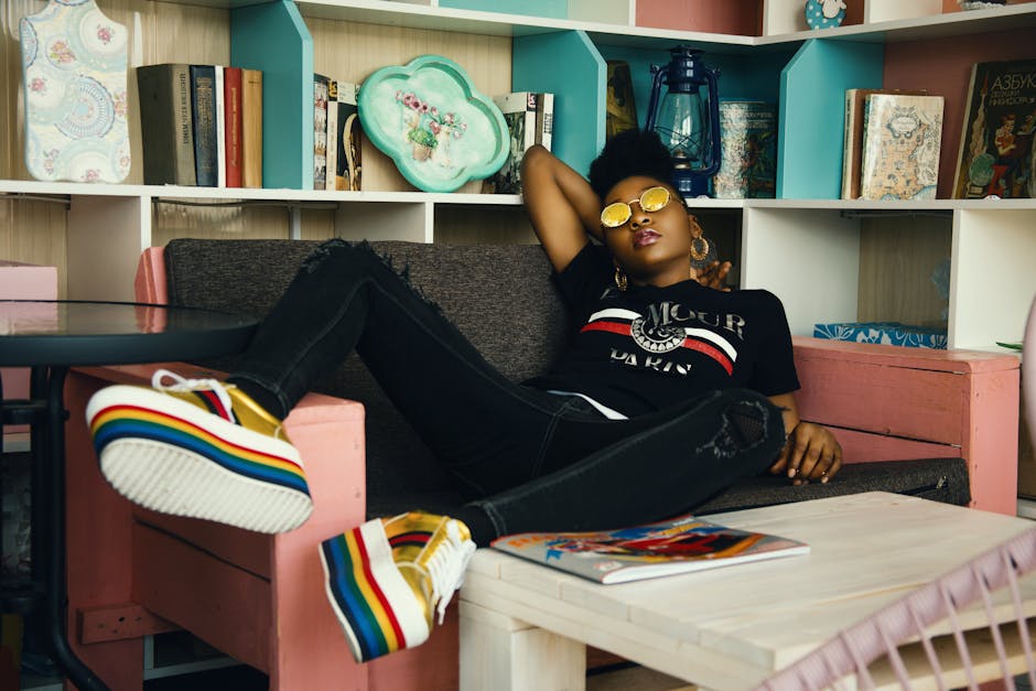 Fashionable woman lounging in a colorful bookstore, showcasing style and relaxation.